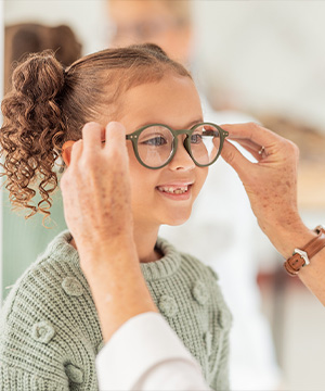 kid trying on glasses